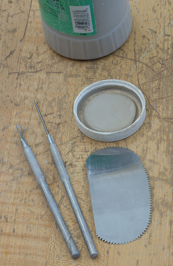 A closer view of a pin tool and serrated scraper