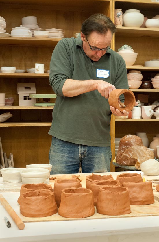 Rob Fornell trimming the inside of some hand-built tea bowls that have yet to have bottoms attached