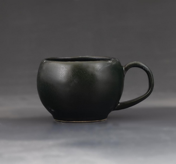 Matte black cup with handle by Annabelle Yip