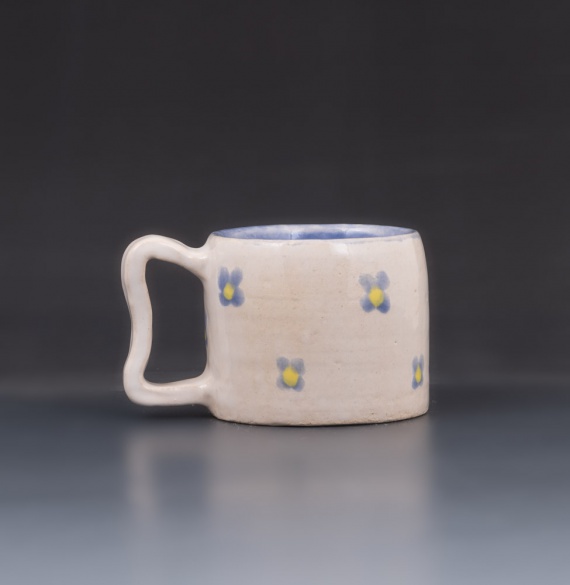 White cup with blue flower pattern by Mozhan Edalati
