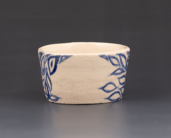 White cup with blue design by Sophia Schumer