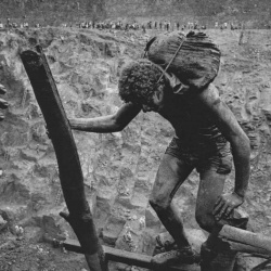<p><b>Sebastião Salgado</b>, <i>GOLD, SERRA PELADA, BRAZIL: Carriers must keep their hands as free as possible to help balance on the dangerous ladders in the struggle from the mine bottom to the top. Serra Pelada, State of Pará, Brazil, 1986.</i></p>