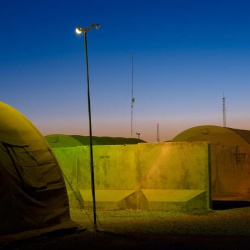 <p><b>Simon Norfolk</b>, <i>Security lights and communications antennae at Camp Leatherneck.</i> 2010-11.</p>