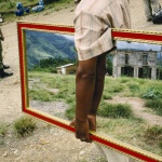 <p><b>Alex Webb</b>, <i>PERU. Palmapampa. 1993. Mirror vendor on a landing strip.</i></p>
