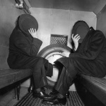 <p><b>Arthur Fellig</b>, <i>In the Paddy Wagon</i>, 1942. Charles Sodokoff and Arthur Webber Use Their Top Hats to Hide Their Faces.</p>