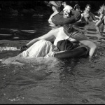 <p><b>Burt Glinn</b>, <i>USA. Seattle, Washington. 1953. A lady member of the Seattle Tubing Society wears a fancy hat as she floats along the Sammamish Slough.</i></p>
