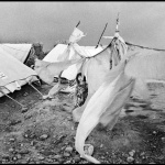 <p><b>Christopher Anderson</b>. PAKISTAN. 2001. Afghan refugees in refugee camps near Peshewar. A girl stands amid tents torn by a wind storm.</p>