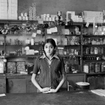 <p><b>David Goldblatt</b>, <i>The Modi's daughter in their shop before its destruction under the Group Areas Act, Fietas</i>, 1977.</p>