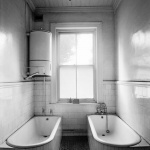 <p><b>David Goldblatt</b>, <i>Bathroom attached to the office of the General Manager with 'dirty' bath and 'clean' bath for his use after he had been underground. New Kleinfontein Gold Mine, Benoni</i>, May 1967.</p>