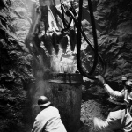 <p><b>David Goldblatt</b>, <i>Hailed by the team, the cactus grab dumps a load of rock into a kibble. The driver of the grab swings the machine around the confined space of the shaft in seemingly manic abandon as he seeks mouthfuls of rock. The men, lithe and nimble, dodge the grab while helping to feed its digestion in a coming and going of empty and full kibbles</i>, 1969.</p>