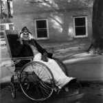 <p><b>Diane Arbus</b>, <i>Masked Woman in Wheelchair, PA. 1970</i>.</p>