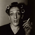 <p><b>Diane Arbus</b>, <i>A young man in curlers at home on West 20th Street, N.Y.C. 1966</i>.</p>