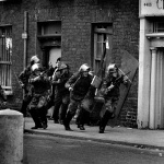 <p><b>Don McCullin</b>, <i>Soldiers from the Royal Anglian Regiment counter-attack young Catholic stone-throwers in The Bogside, Londonderry, Northern Ireland, 1971</i>.</p>