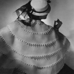 <p><b>Horst P. Horst</b>, <i>Model wearing a white sailor hat with veil and a tiered organdy cape edged with rickrack, both by Lanvin</i>, Vogue, April 1935.</p>