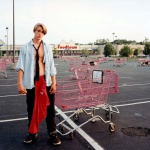<p><b>Joel Sternfeld</b>, <i>Young Man Gathering Shopping Carts, Huntington, New York, July 1993.</i></p>