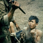 <p><b>Larry Burrows</b>, <i>A bayonet-wielding South Vietnamese paratrooper threatens a captured Việt Cộng suspect during an interrogation</i>, 1962.</p>