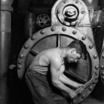 <p><b>Lewis Hine</b>, <i>Power house mechanic working on steam pump</i>, 1920.</p>
