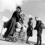 <p><b>Margaret Bourke-White</b>, <i>A pair pulling a handcart loaded with three children and food, Germany</i>, April 1945.</p>