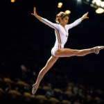 <p><b>Neil Leifer</b>, <i>Nadia Comaneci of Romania leaps off the balance beam during the gymnastics competition of the 1976 Summer Olympics at the Montreal Forum. Montreal, Canada 7/19/1976.</i></p>