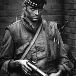 <p><b>Philip Jones Griffiths</b>, <i>GB. NORTHERN IRELAND. This soldier was facing a hostile crowd of youngsters and, for a moment, his expression revealed his disdain. 1972</i></p>