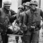 <p><b>Philip Jones Griffiths</b>, <i>VIETNAM. Hue. US Marines inside the Citadel rescue the body of a dead Marine during the Tet Offensive. 1968</i></p>