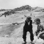 <p><b>Robert Capa</b>, <i>ITALY. Near Troina. August 4-5, 1943. Sicilian peasant telling an American officer which way the Germans had gone.</i></p>