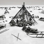 <p><b>Sebastião Salgado</b>, <i>THE NENETS: At the end of the day, after leading the herd north across the Yamal Peninsula towards the Kara Sea on the Arctic Ocean, the Nenets set up their tent, or </i>tchoum<i>. They first put all their belongings in a circle on the ground, around which they place wooden supports covered with reindeer skins. North of Ob River, Yamal Peninsula, Siberia, Russia, March-April 2011.</i></p>