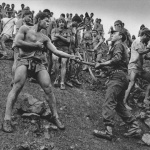 <p><b>Sebastião Salgado</b>, <i>GOLD, SERRA PELADA, BRAZIL: The mines are controlled by state civil guardsmen, known to make lower wages than the carriers; often rivalries occur. Uniformed guards are proud of their status but don't want to be considered lower than mine workers because of their wages. Sometimes fighting and killings result: a guard who had shot a worker was stoned to death by carriers during such a battle. Serra Pelada, State of Pará, Brazil, 1986.</i></p>