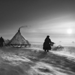 <p><b>Sebastião Salgado</b>, <i>THE NENETS: North of the Ob River, about 62 miles (100 kilometers) inside the Yamal Peninsula, fierce winds keep even daytime temperatures low. When the weather is particularly hostile, the Nenets and their reindeer may spend several days in the same place, doing repair work on sledges and reindeer skins to keep busy. The deeper they move into the Arctic Circle, the less vegetation is to be found. Inside the Arctic Circle, Yamal Peninsula, Siberia, Russia, March-April 2011.</