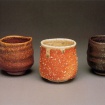 Shaner's Red Tea Bowl, 1993, glazed stoneware, 3.5 x 3.75 x 3.75 in.; Shigaraki-style Tea Bowl, 1988, glazed porcelaineous stoneware, 3.6 x 4 x 4 in.; Maria-glazed Tea Bowl, 1993, glazed stoneware, 3.73 x 3.75 x 3.75 in.: photo (partially cropped) by Anthony Cuñha, from Following The Rhythms Of Life: The Ceramic Art Of David Shaner