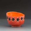 Stamped orange tea bowl by Emma Gastineau