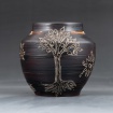 Black vase with carved tree design by Layne Fitzgerald