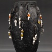 Black vase with hanging ornamentation by Layne Fitzgerald