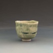 Broken and patched celadon tea bowl by Madeleine Truffat