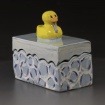Box with rubber ducky wearing a tie on top by Tatev Yeghiazaryan